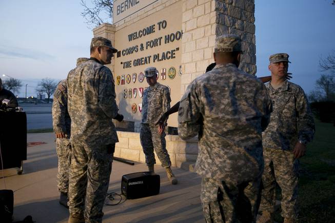 Military personnel wait for a news conference to begin at Fort Hood, Texas, on Wednesday, April 2, 2014. A gunman opened fire in an attack that left four people killed including the shooter, at the same post where more than a dozen people were killed in a 2009 mass shooting, law enforcement officials said. The gunman died of a self-inflicted gunshot wound, officials said. At least 14 people were hurt in the shooting. (AP Photo/Austin American-Statesman, Deborah Cannon)